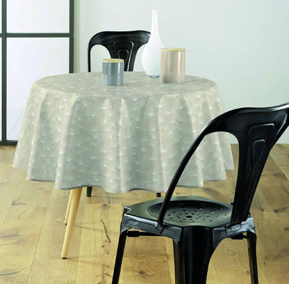 tovaglia antimacchia beige con motivo botanico su tavolo rotondo