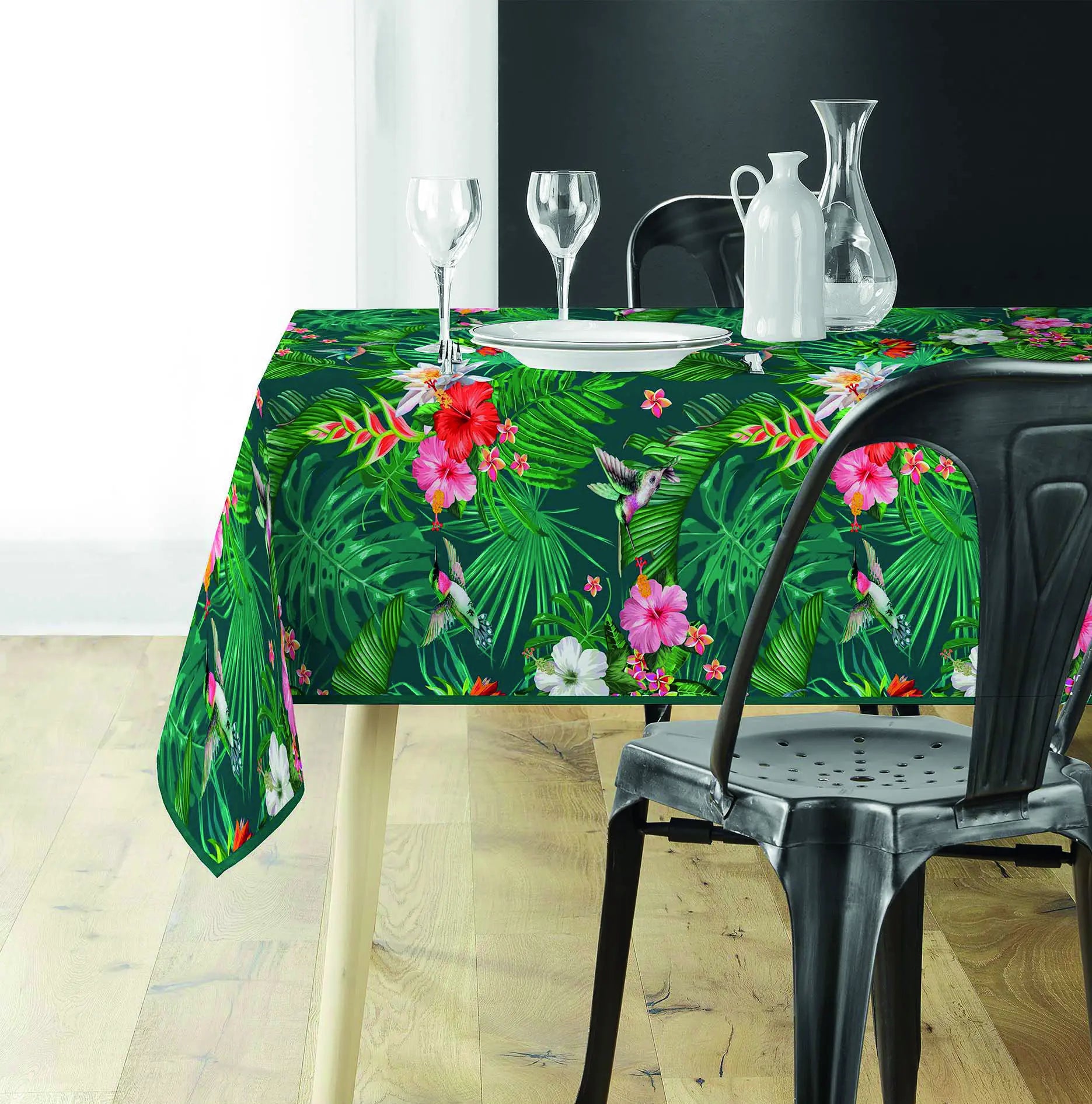 Tovaglia antimacchia verde con fantasia botanica tropicale su tavolo da pranzo